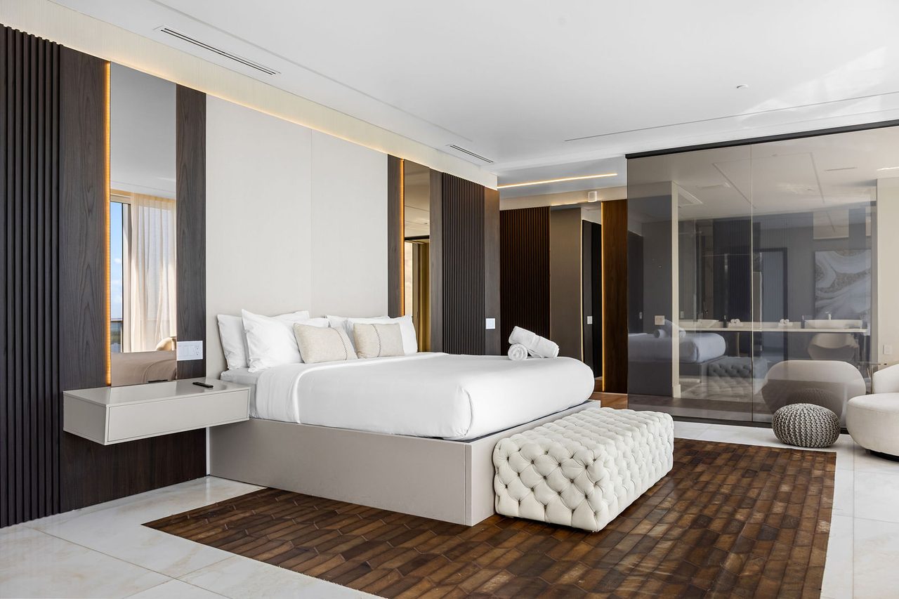 The primary suite, with its glass-walled bath
