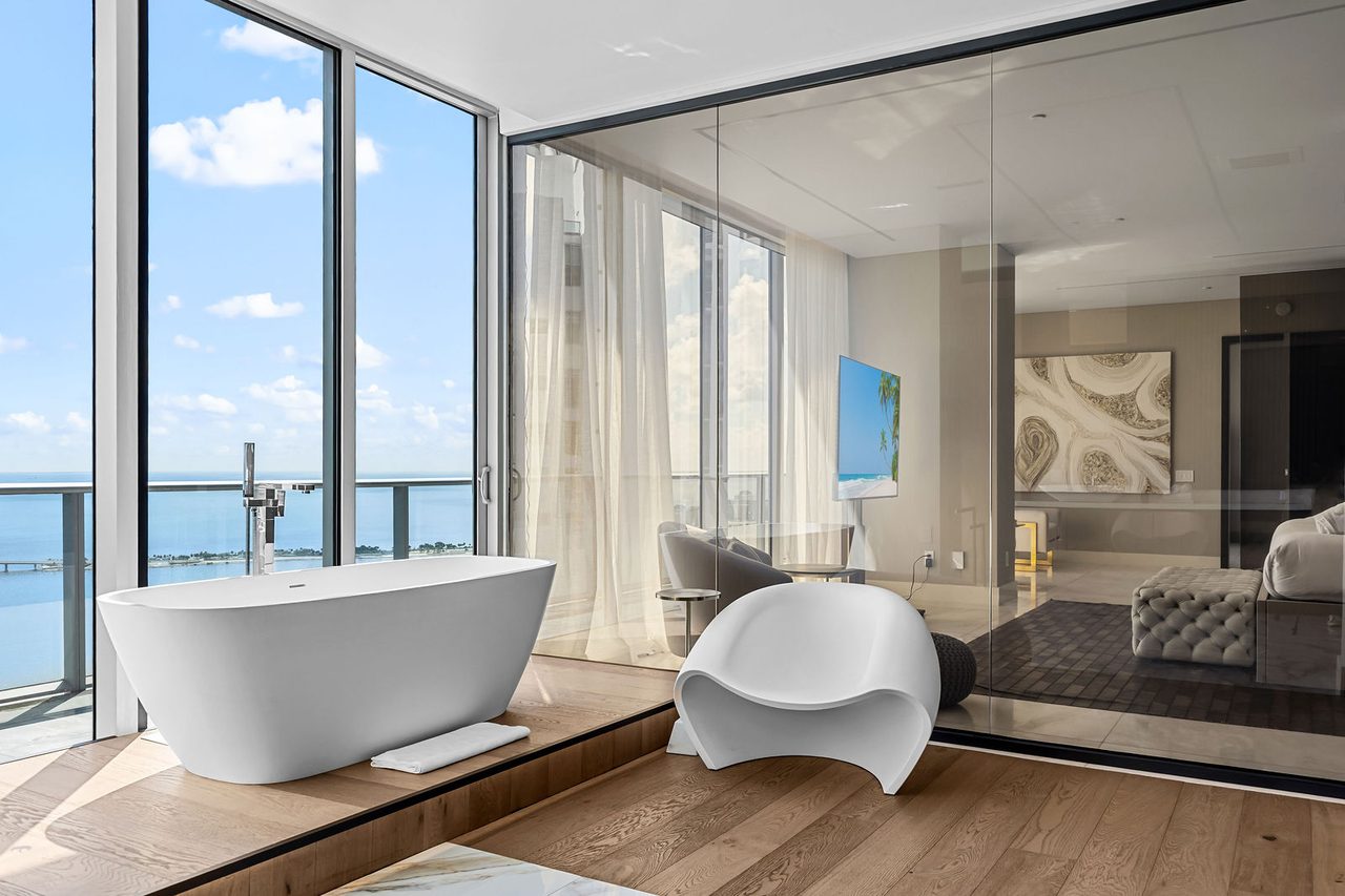 A freestanding tub at the window of the primary bath, over the bay