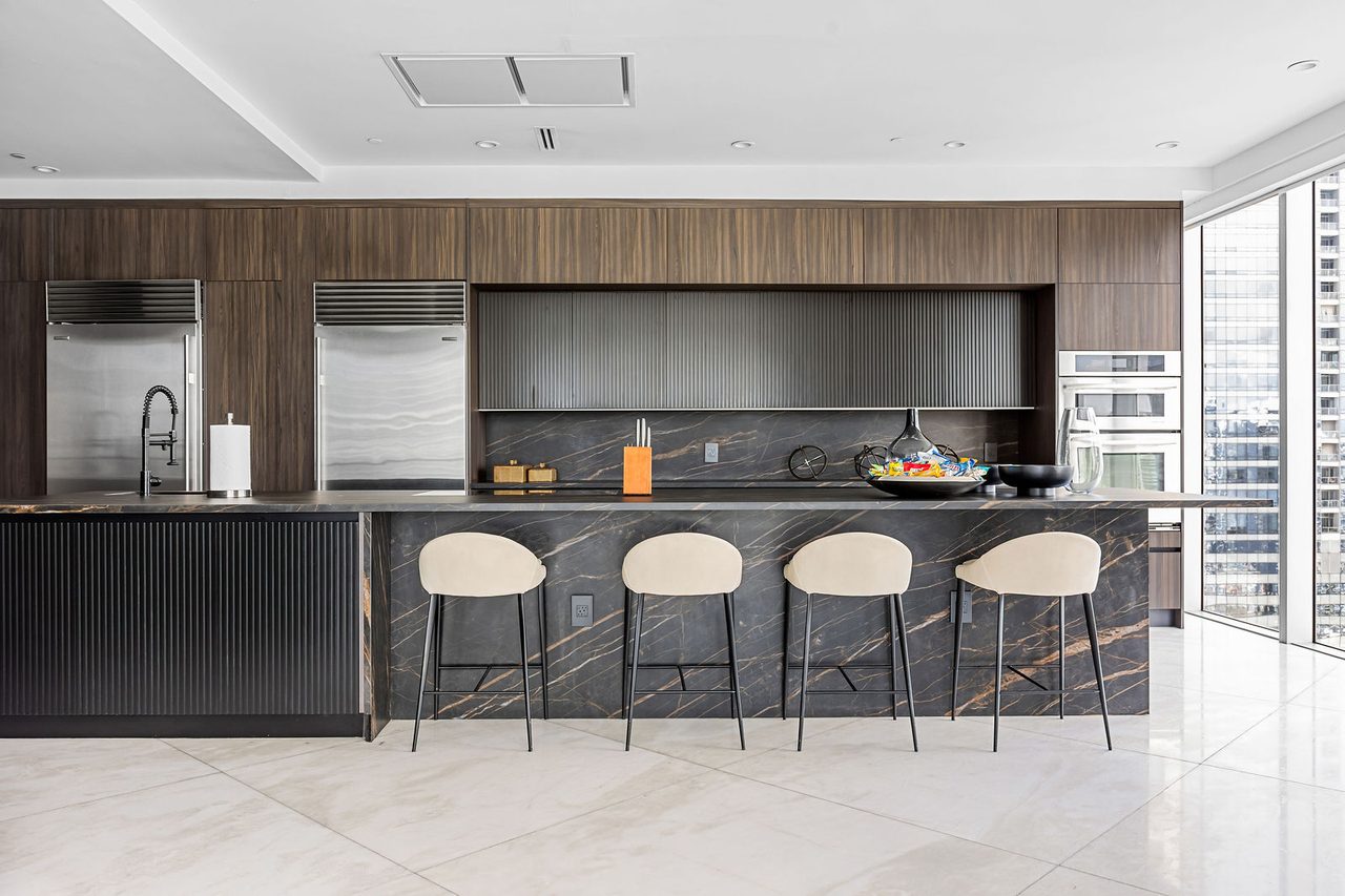 The kitchen: a long stone island with seating for four