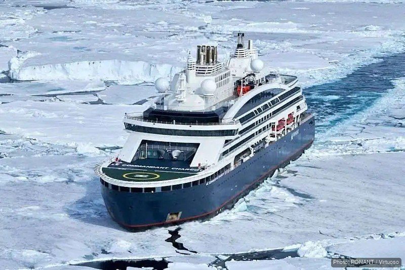 A Ponant polar expedition ship moving through sea ice, seen from above