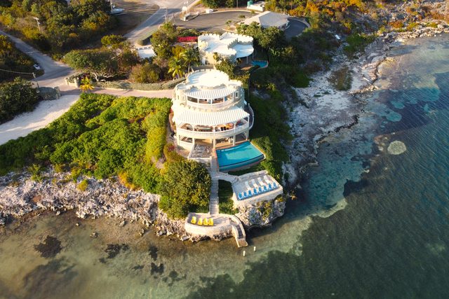 A villa above an empty bay