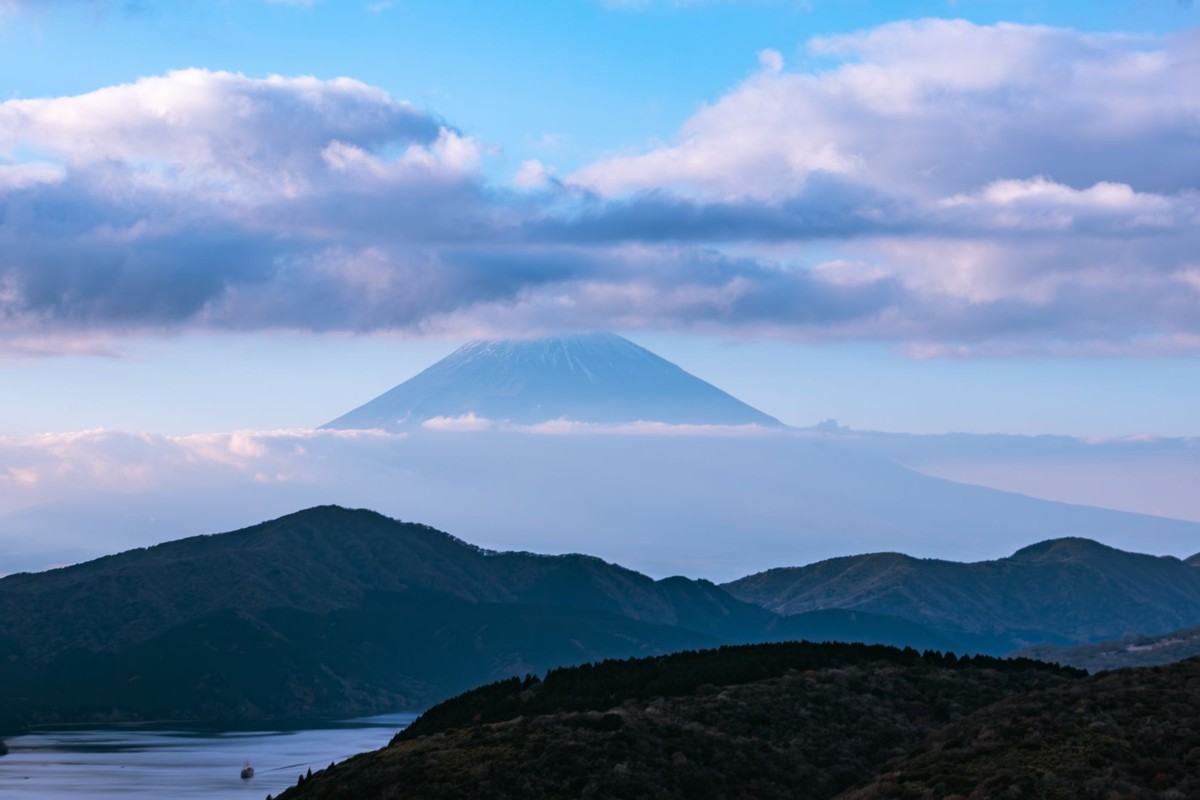 A private onsen at dawn with Fuji visible